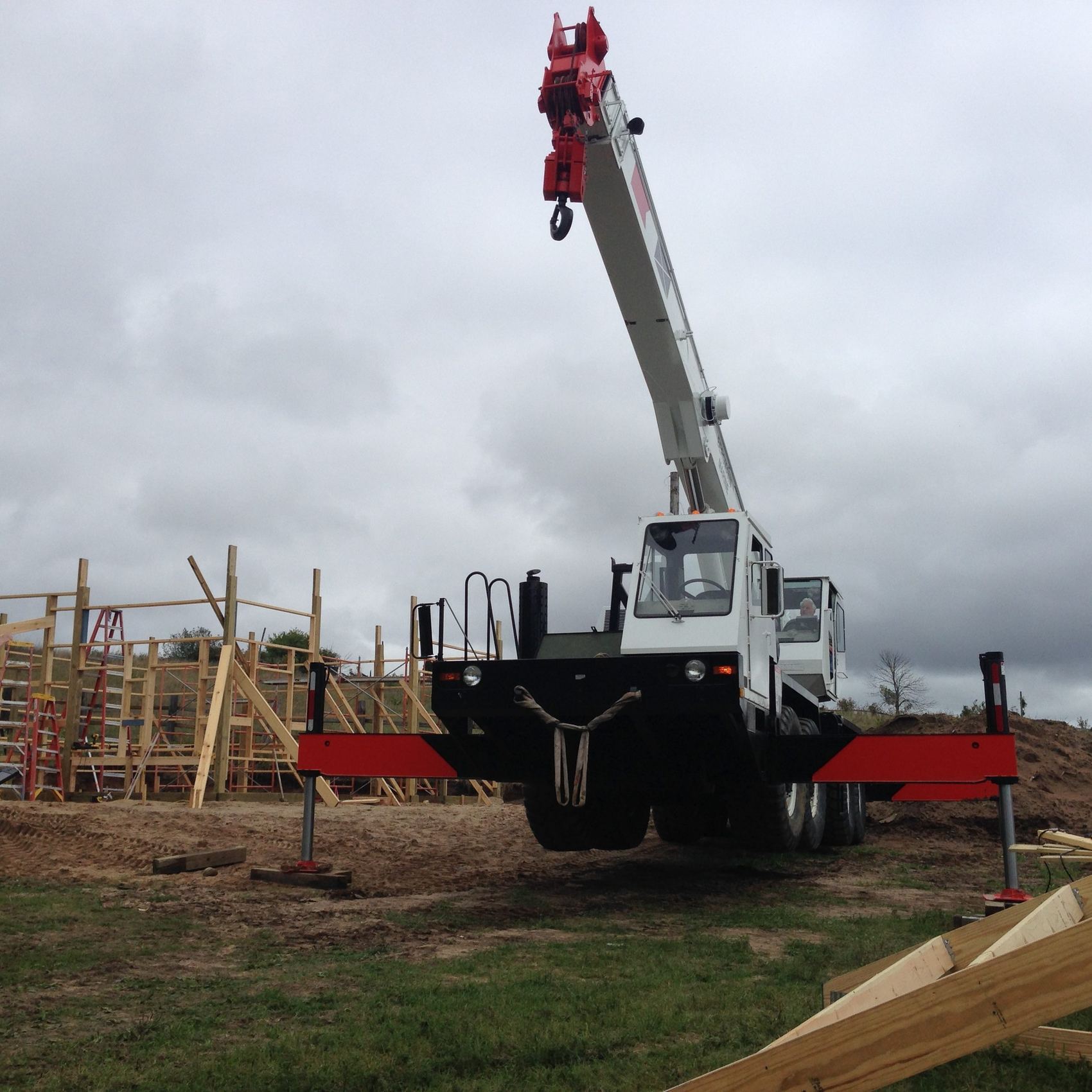 Crane on site during framing and roof work on a new home