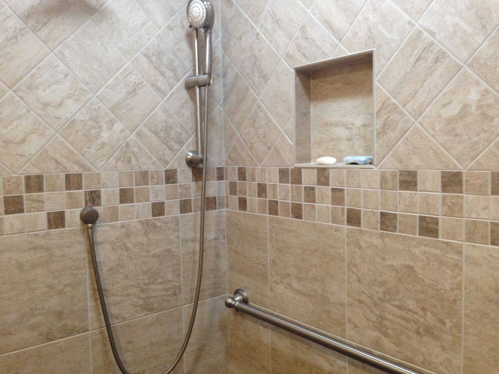 Remodeled bathroom with a custom tile shower and niche